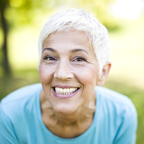 Senior woman with implant dentures in Willowbrook, IL smiling