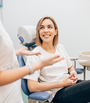 Woman discussing available dental services with dentist
