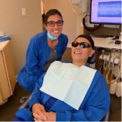 Smiling dental team member and patient in dental office